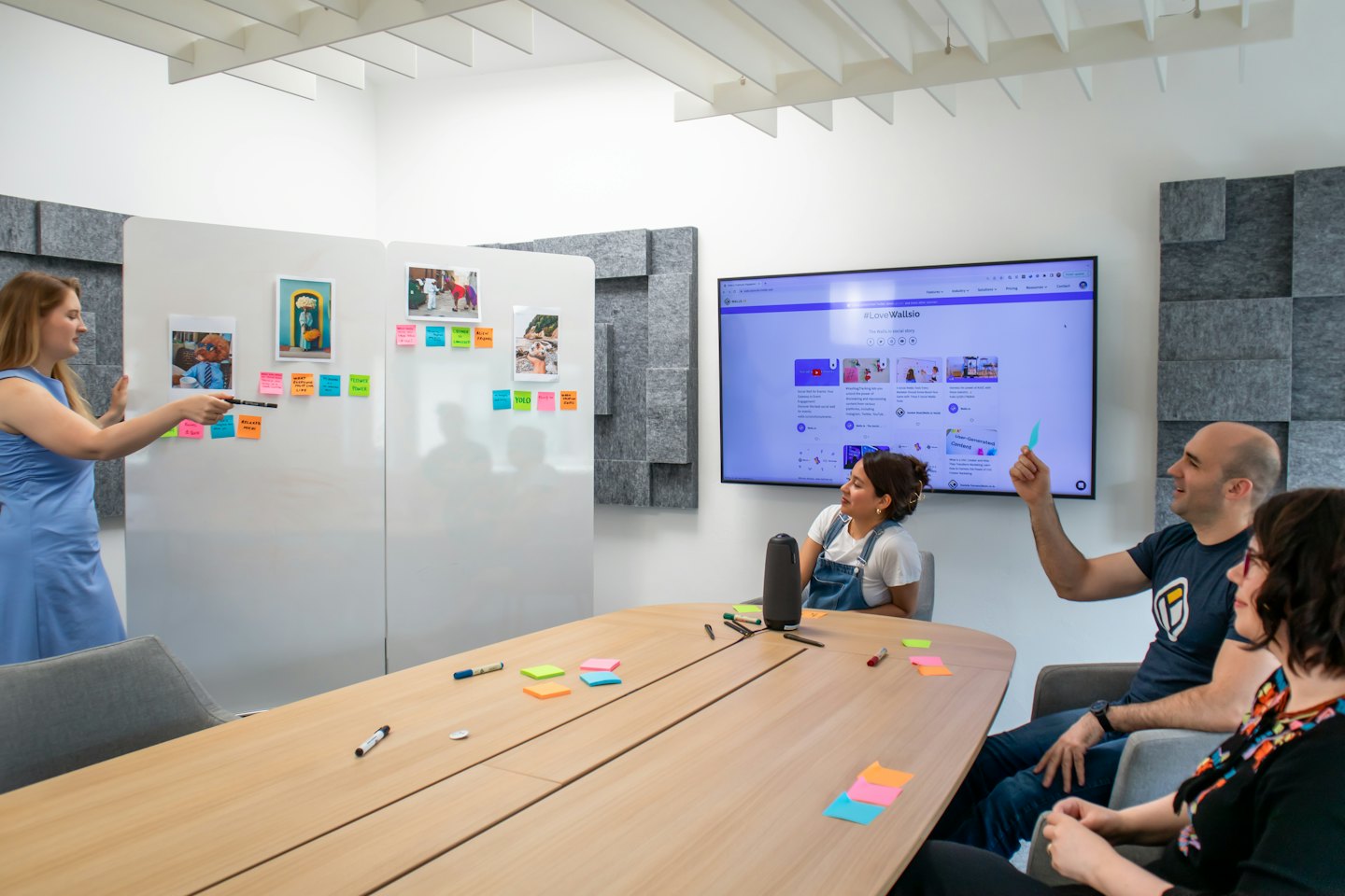 Colleagues brainstorm ideas with sticky notes on a whiteboard.